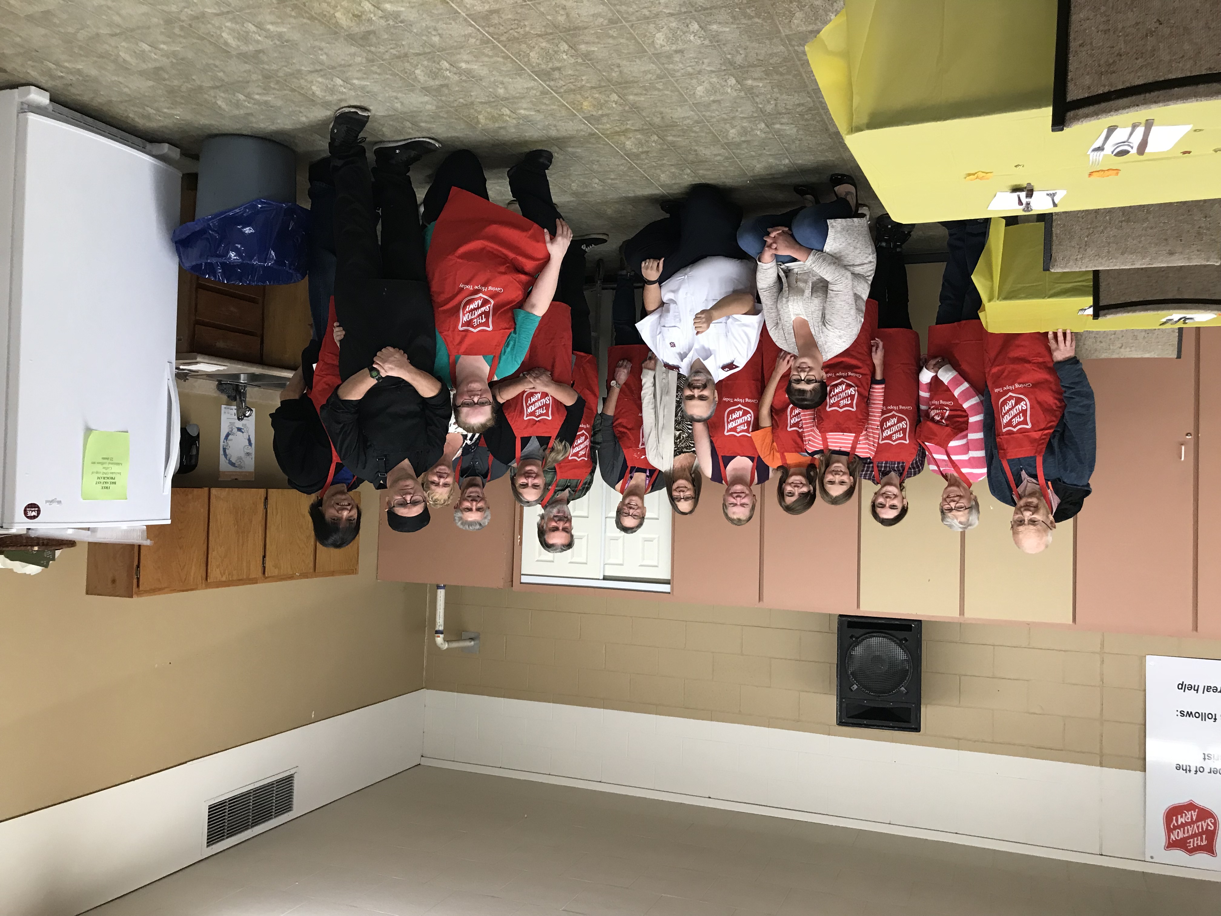 Members of the Williams Lake Corps gathered for a community dinner, wearing Salvation Army aprons.